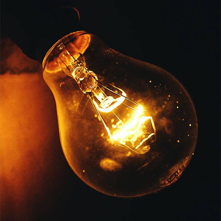 A light bulb with its reflection in it.